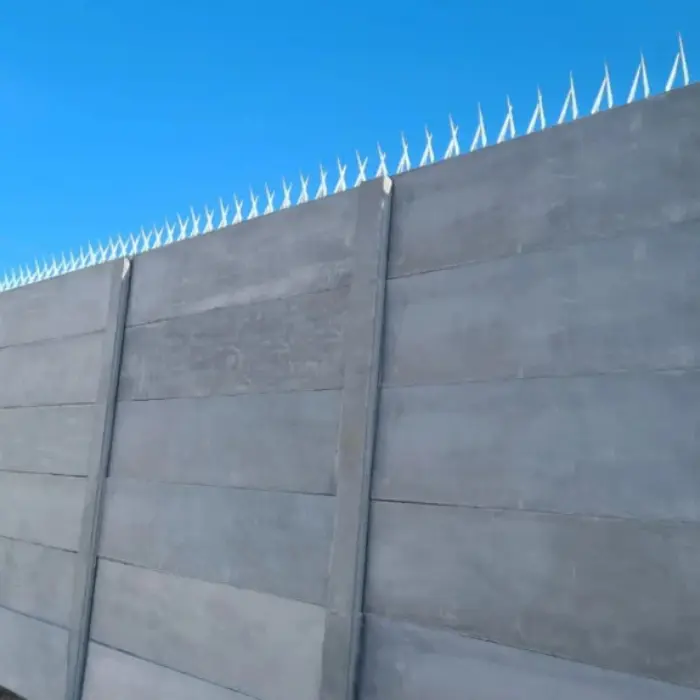 Cierre perimetral de hormigón tipo pandereta coronado con puntas de seguridad para máxima disuasión, una medida de protección que Gestión inversión implementa.
